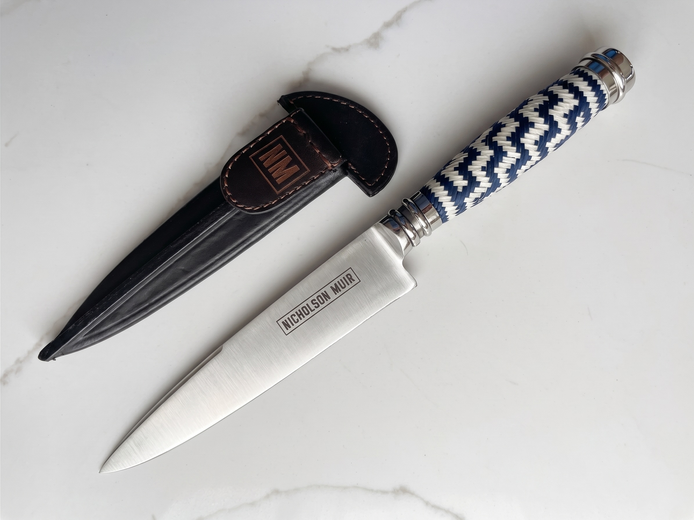 A custom Nicholson Muir table knife beside its leather sheath